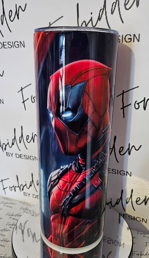 Black insulated tumbler featuring Spider-Man in red suit and blue accents, displayed against a branded backdrop