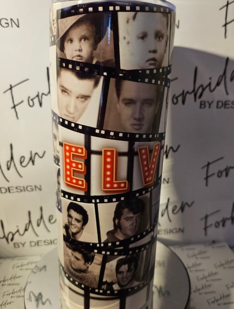 Cylindrical object decorated with film strip pattern featuring multiple black and white portrait photos and red FLY text